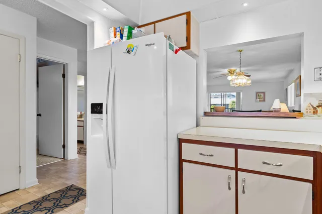 a kitchen with a refrigerator and a sink