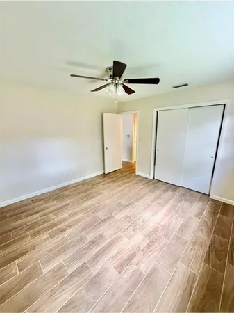 a view of a ceiling fan and hardwood floor