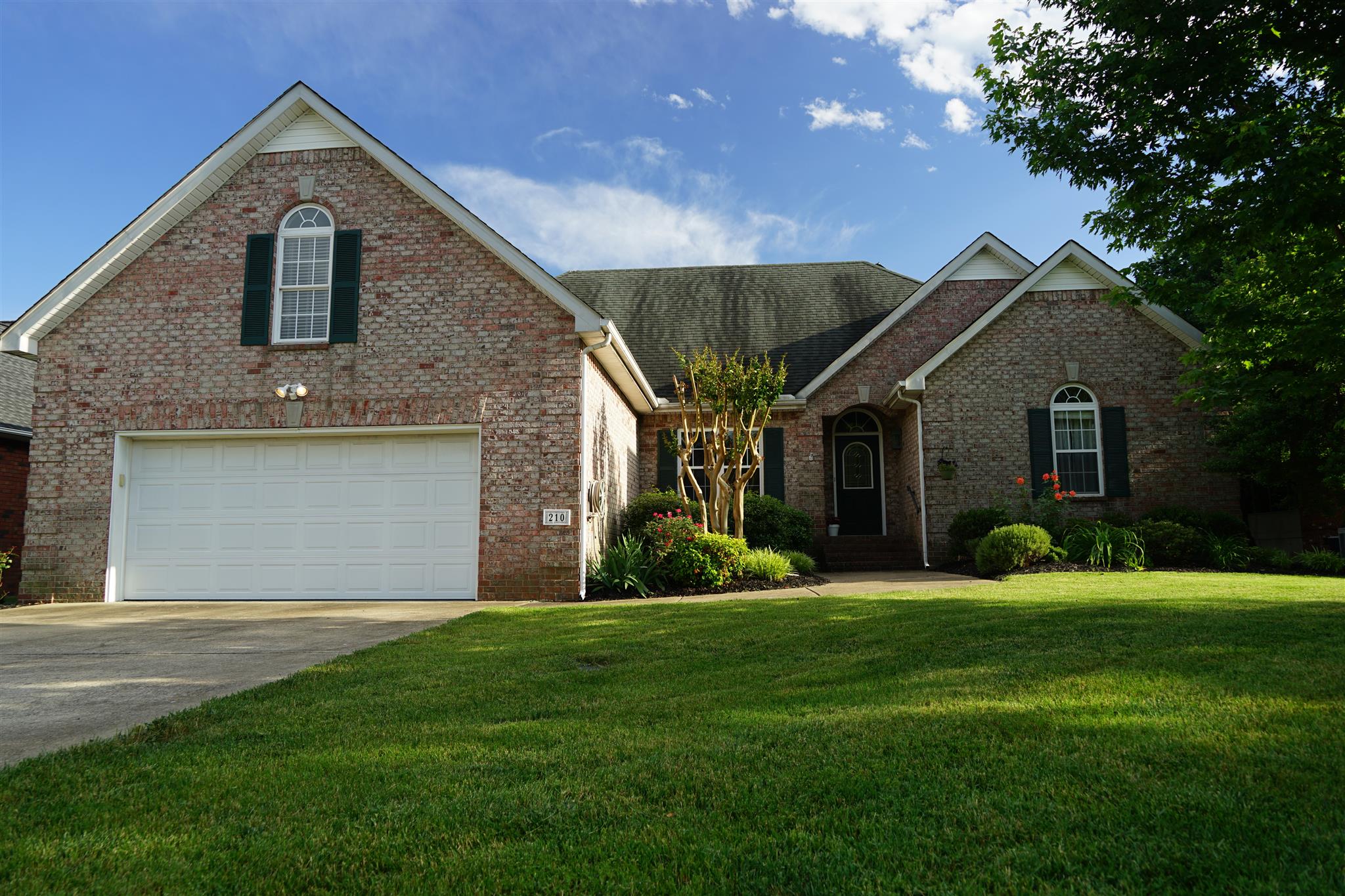 210 Black Bear Trail Murfreesboro, TN 37127 - Photo 1 of 27 a front view of a house with a yard and garage