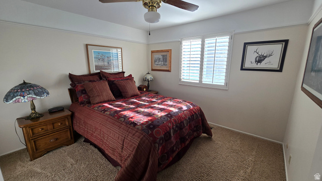 11077 Susan Drive Sandy, UT 84092 - Photo 18 of 20 Carpeted bedroom featuring a ceiling fan and baseboards
