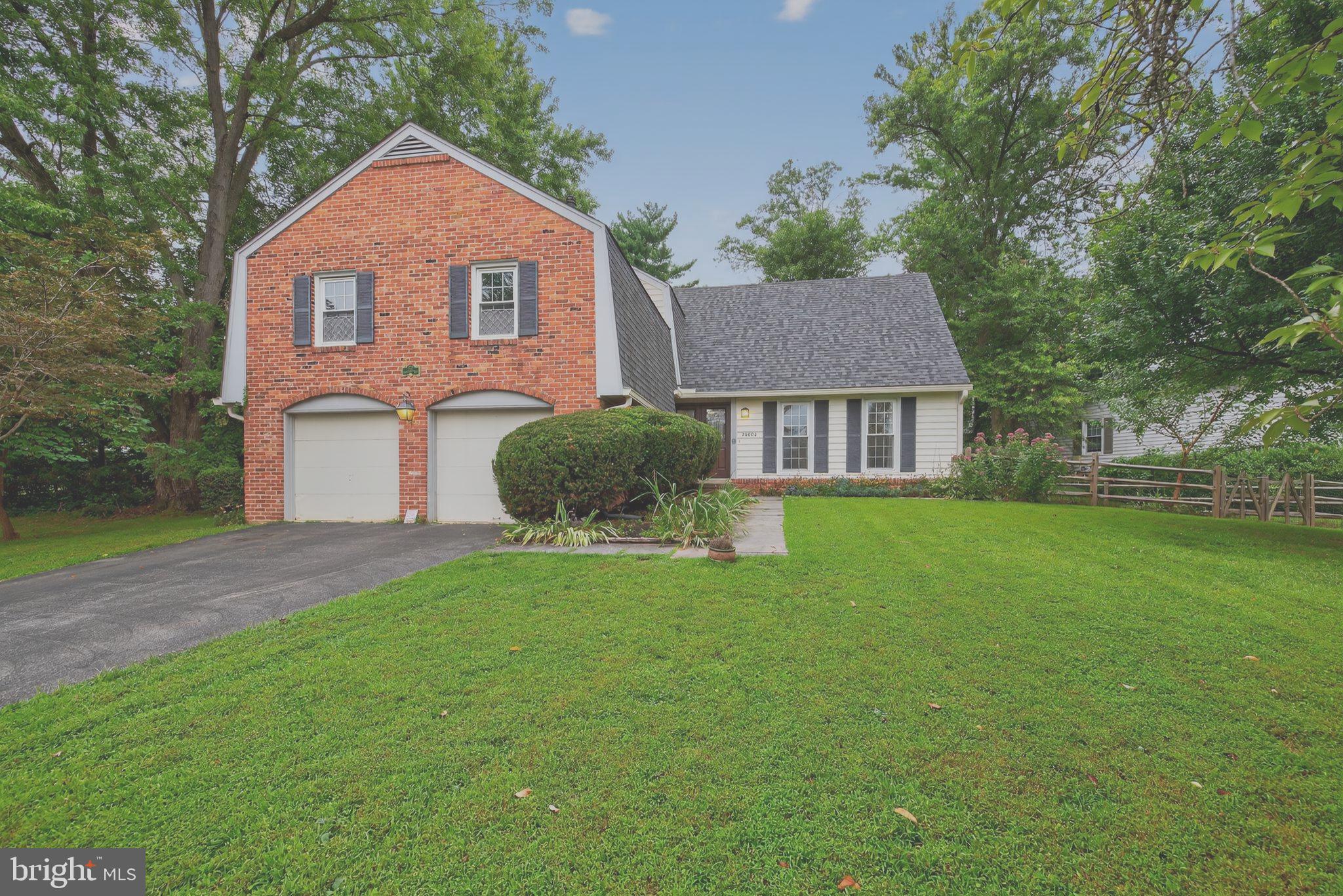20080 Doolittle Street Gaithersburg, MD 20886 - Photo 1 of 48 a front view of a house with a garden and yard