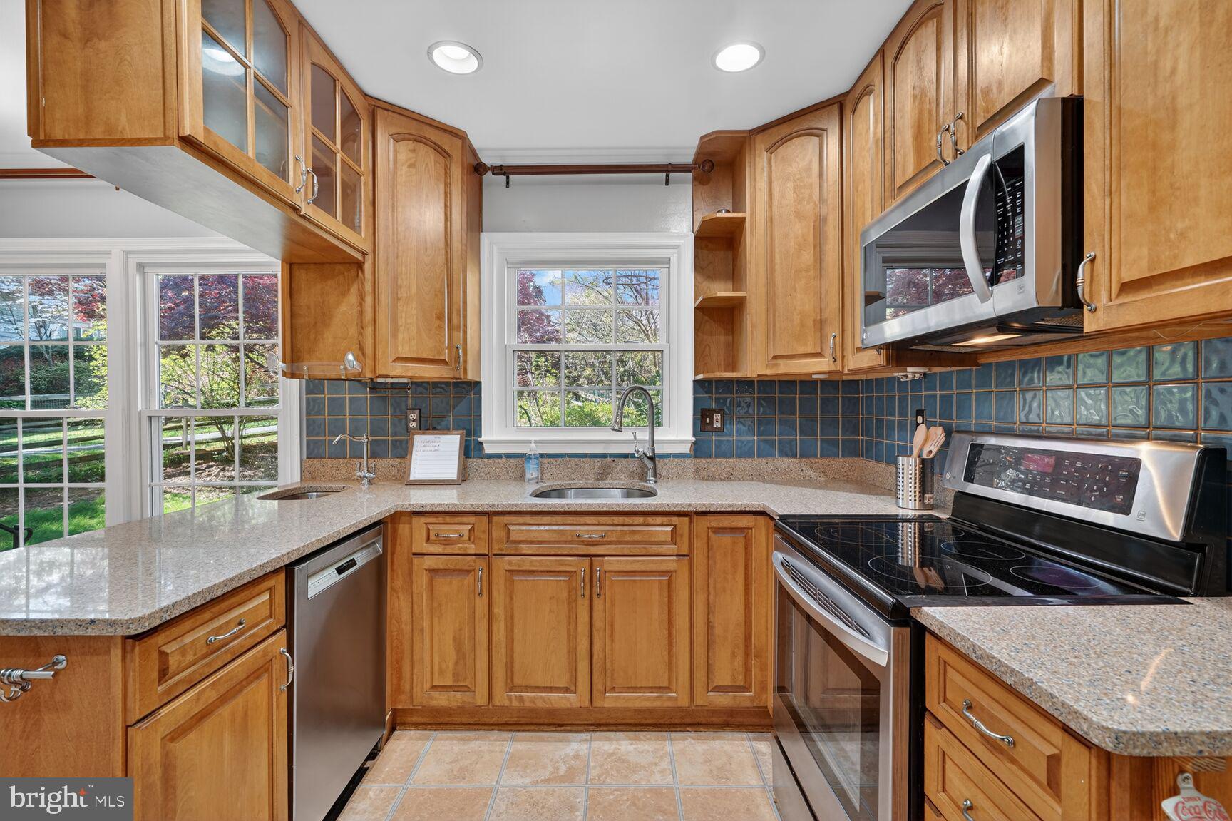 20080 Doolittle Street Gaithersburg, MD 20886 - Photo 12 of 48 a kitchen with stainless steel appliances granite countertop a sink and a microwave