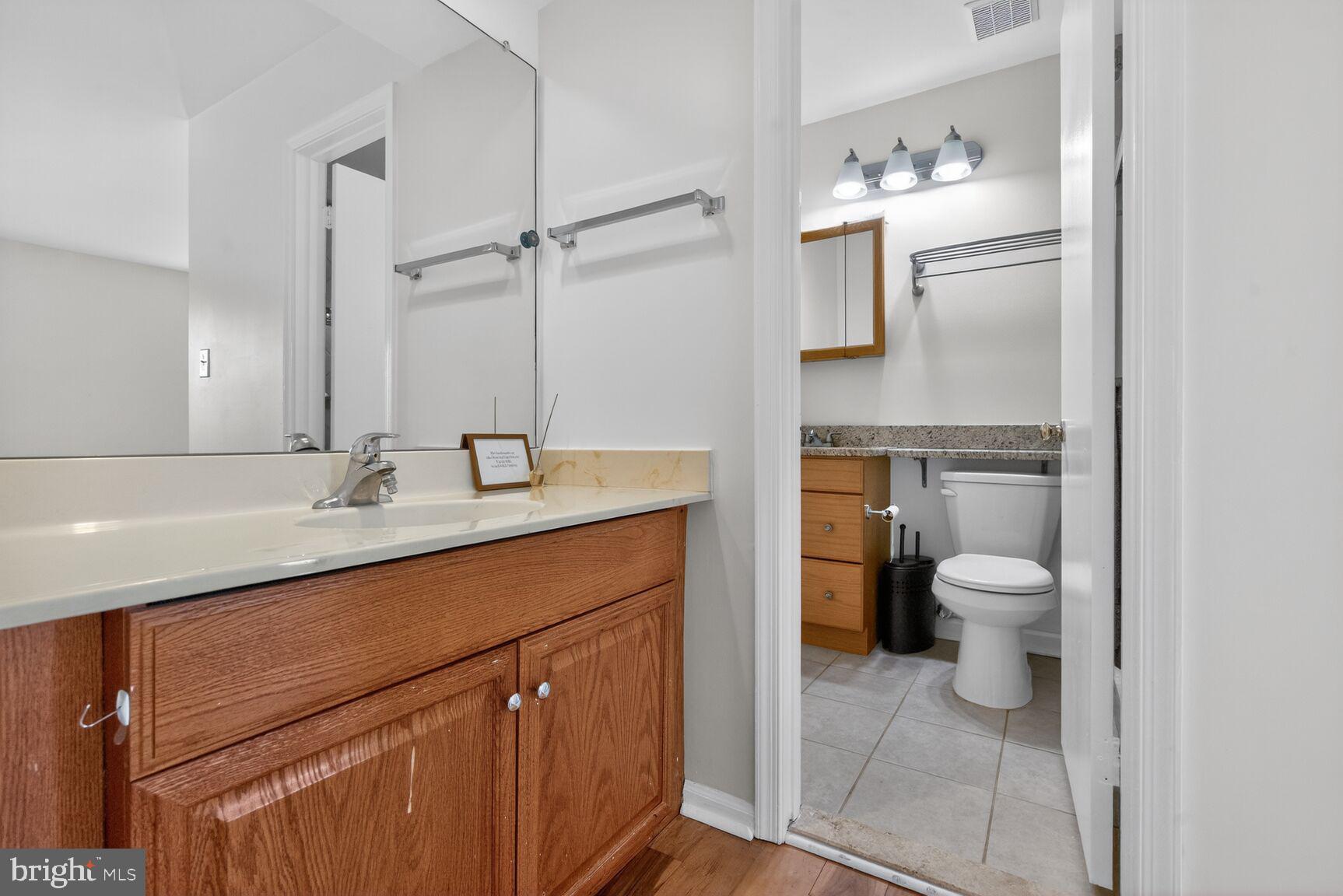 20080 Doolittle Street Gaithersburg, MD 20886 - Photo 22 of 48 a bathroom with a toilet sink and mirror