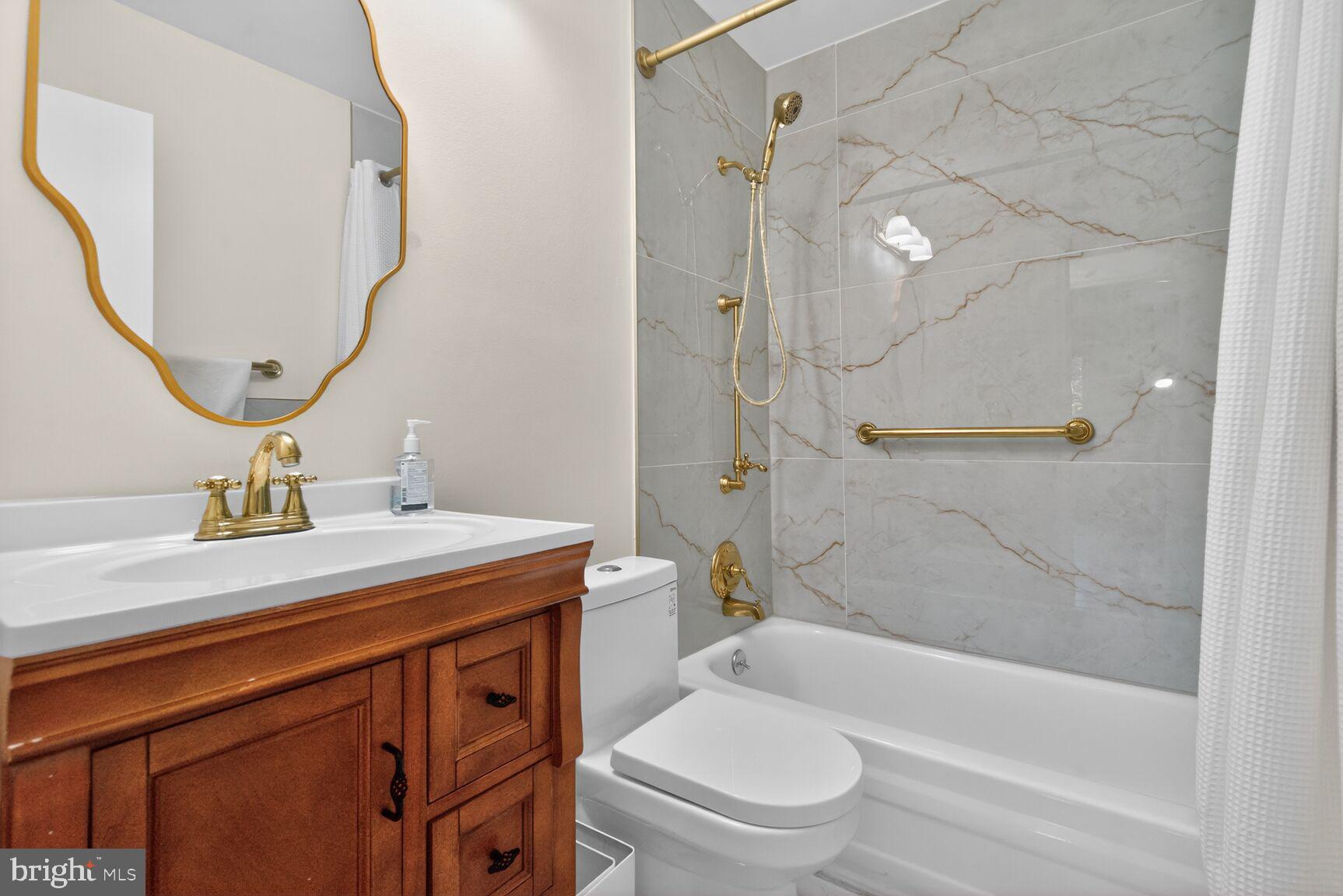 20080 Doolittle Street Gaithersburg, MD 20886 - Photo 28 of 48 a bathroom with a sink a toilet and a mirror