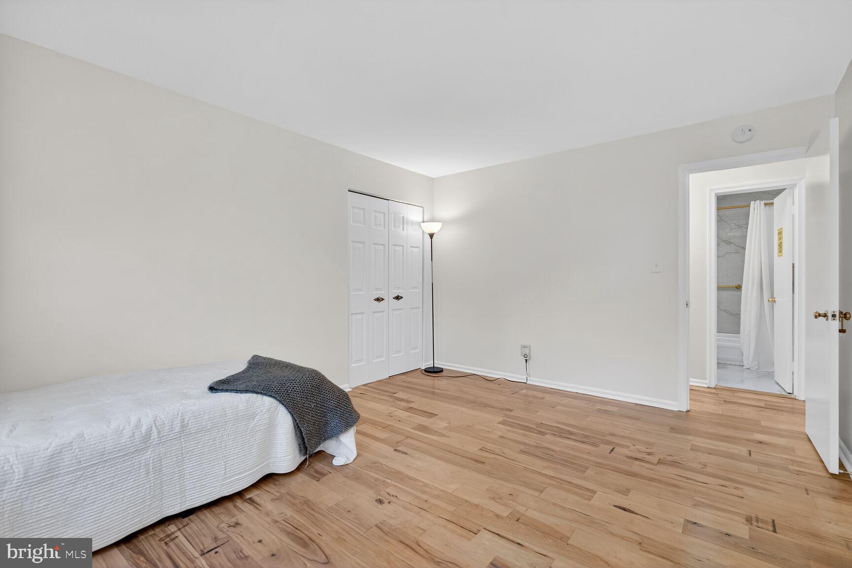 20080 Doolittle Street Gaithersburg, MD 20886 - Photo 29 of 48 a bedroom with a bed and wooden floor