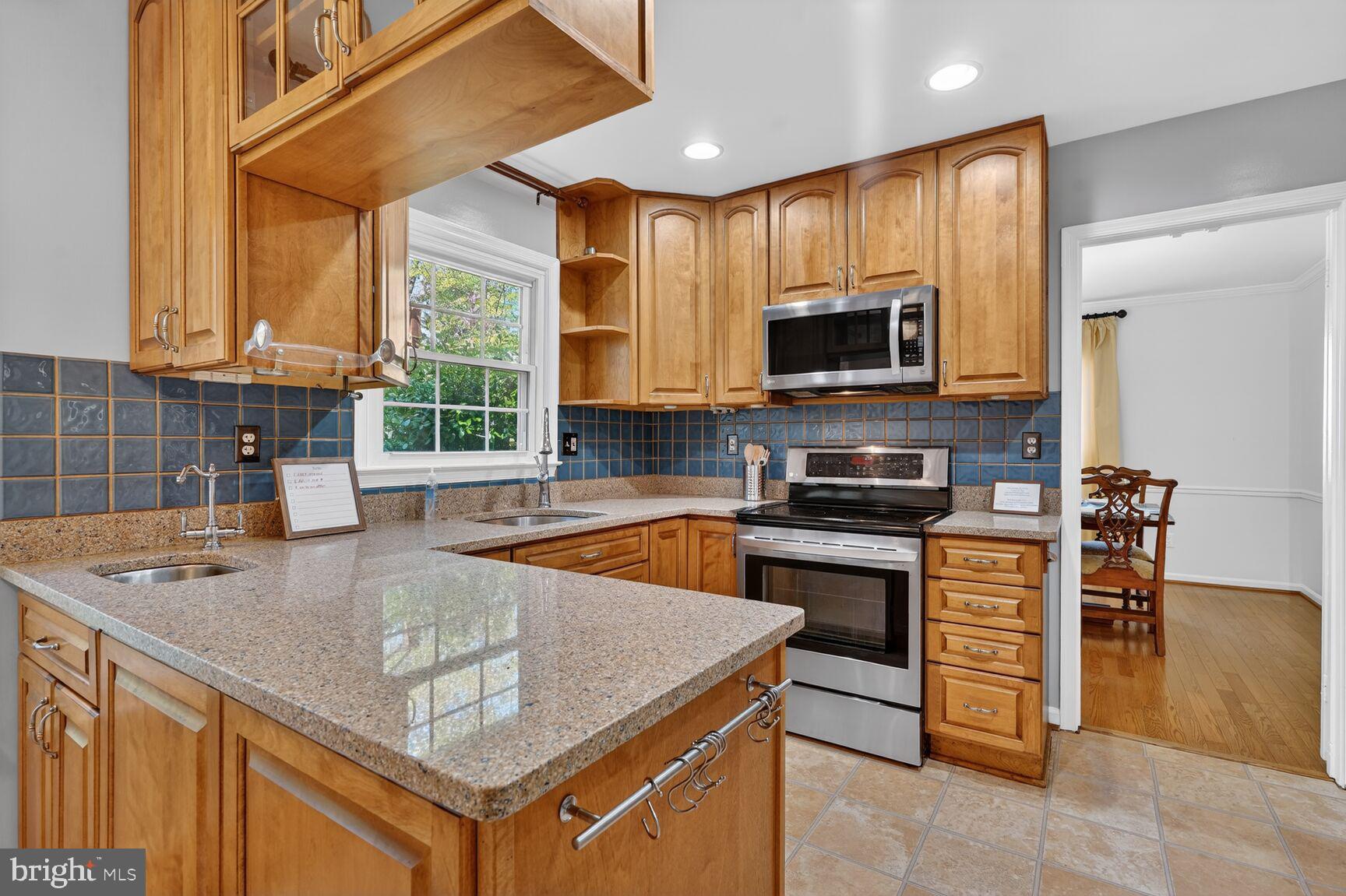 20080 Doolittle Street Gaithersburg, MD 20886 - Photo 9 of 48 a kitchen with a stove a sink and a microwave