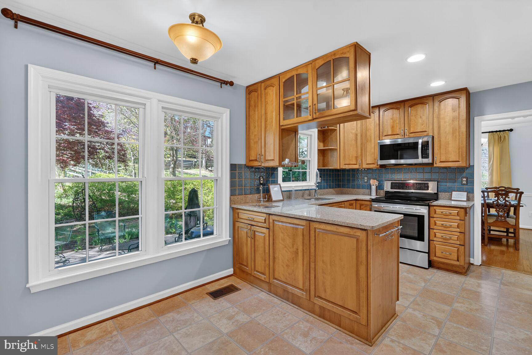 20080 Doolittle Street Gaithersburg, MD 20886 - Photo 10 of 48 a kitchen with stainless steel appliances granite countertop a stove a sink and a microwave
