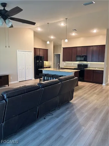 a living room with furniture and a wooden floor