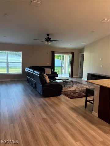 a living room with furniture and a wooden floor