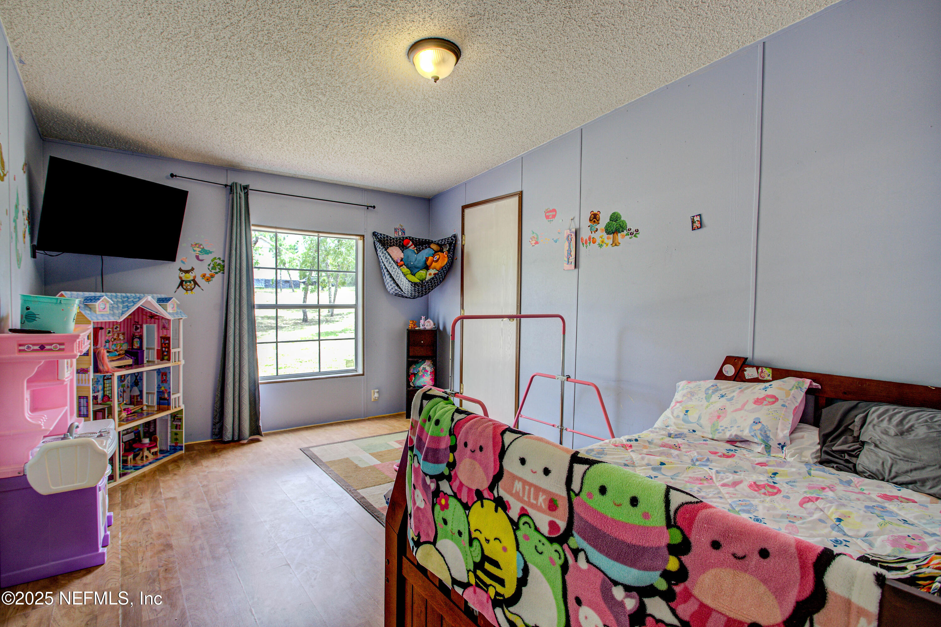 7630 Oak Forest Road Keystone Heights, FL 32656 - Photo 28 of 70 a bedroom with bed and a flat screen tv