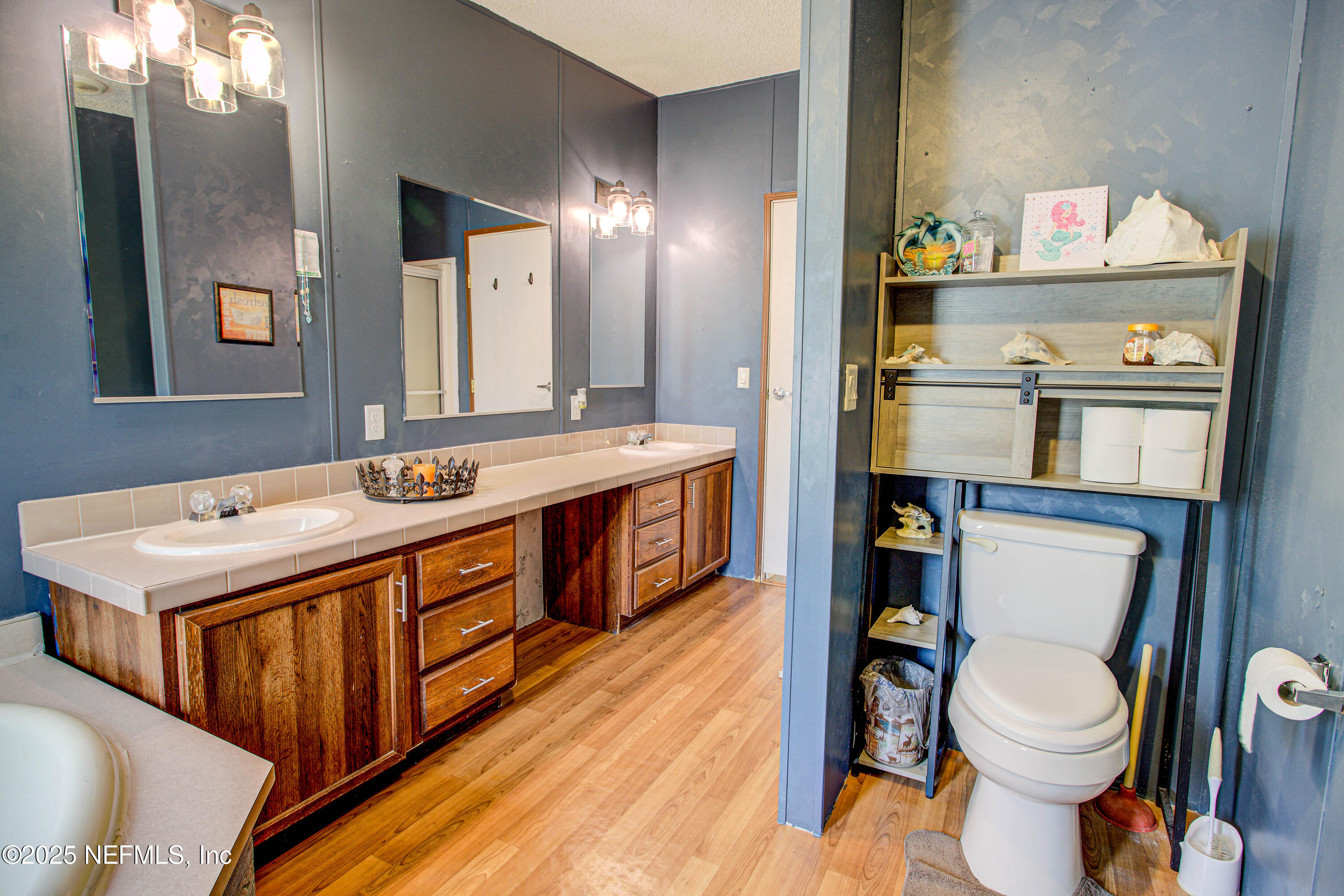 7630 Oak Forest Road Keystone Heights, FL 32656 - Photo 43 of 70 a bathroom with a sink a toilet and a mirror