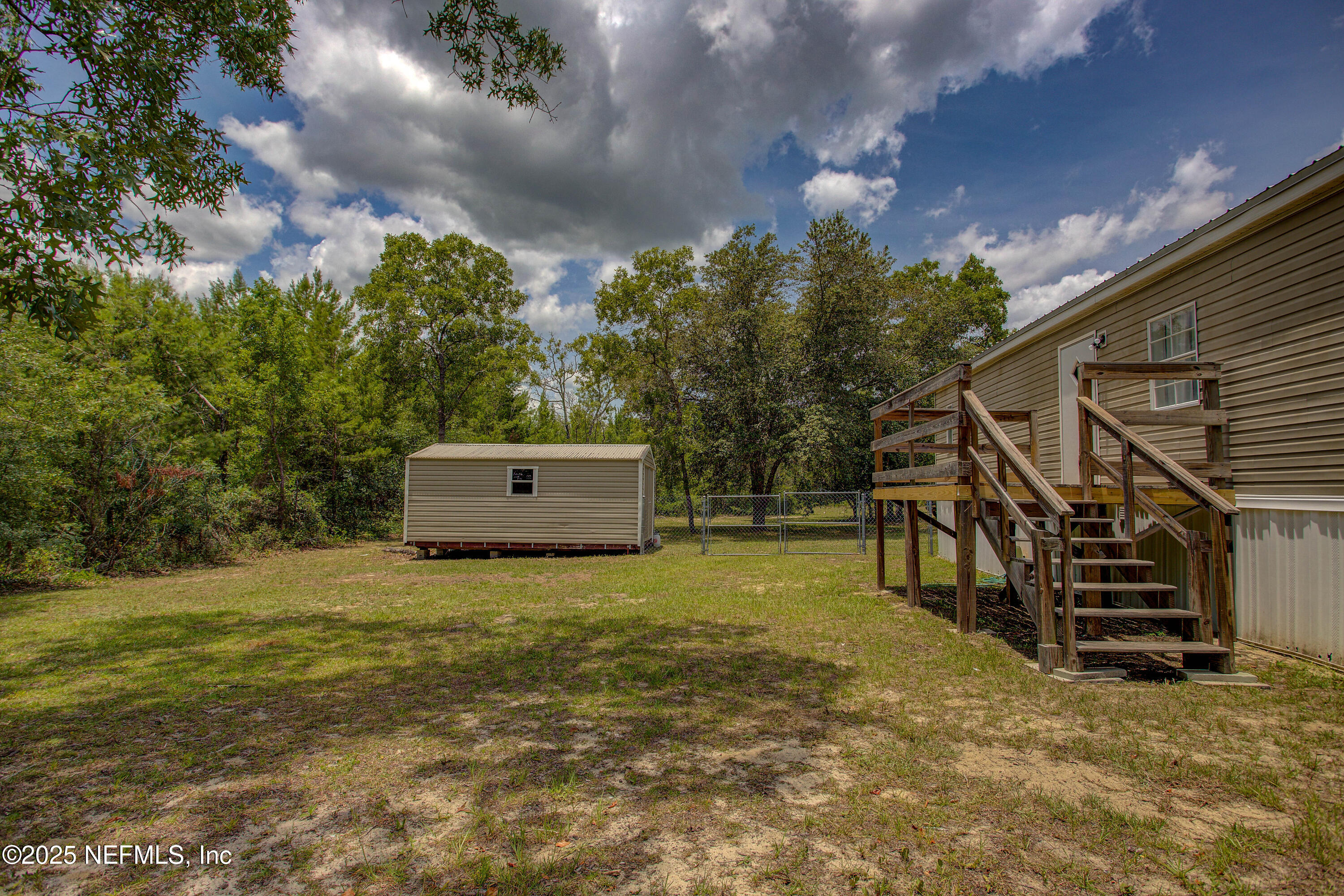 7630 Oak Forest Road Keystone Heights, FL 32656 - Photo 49 of 70 a backyard of a house with a yard and stairs