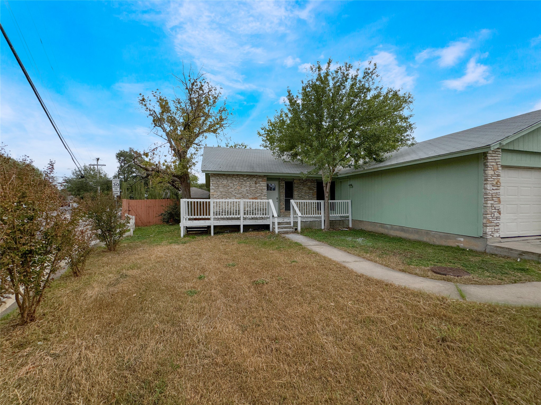 2017 Greenbrook Parkway, Unit B Austin, TX 78723 - Photo 1 of 14 View of front of home featuring stone siding, an attached garage, and a deck
