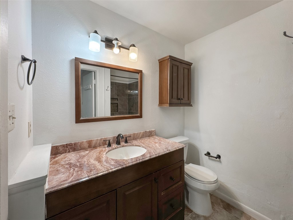 2017 Greenbrook Parkway, Unit B Austin, TX 78723 - Photo 14 of 14 a bathroom with a granite countertop sink toilet and mirror