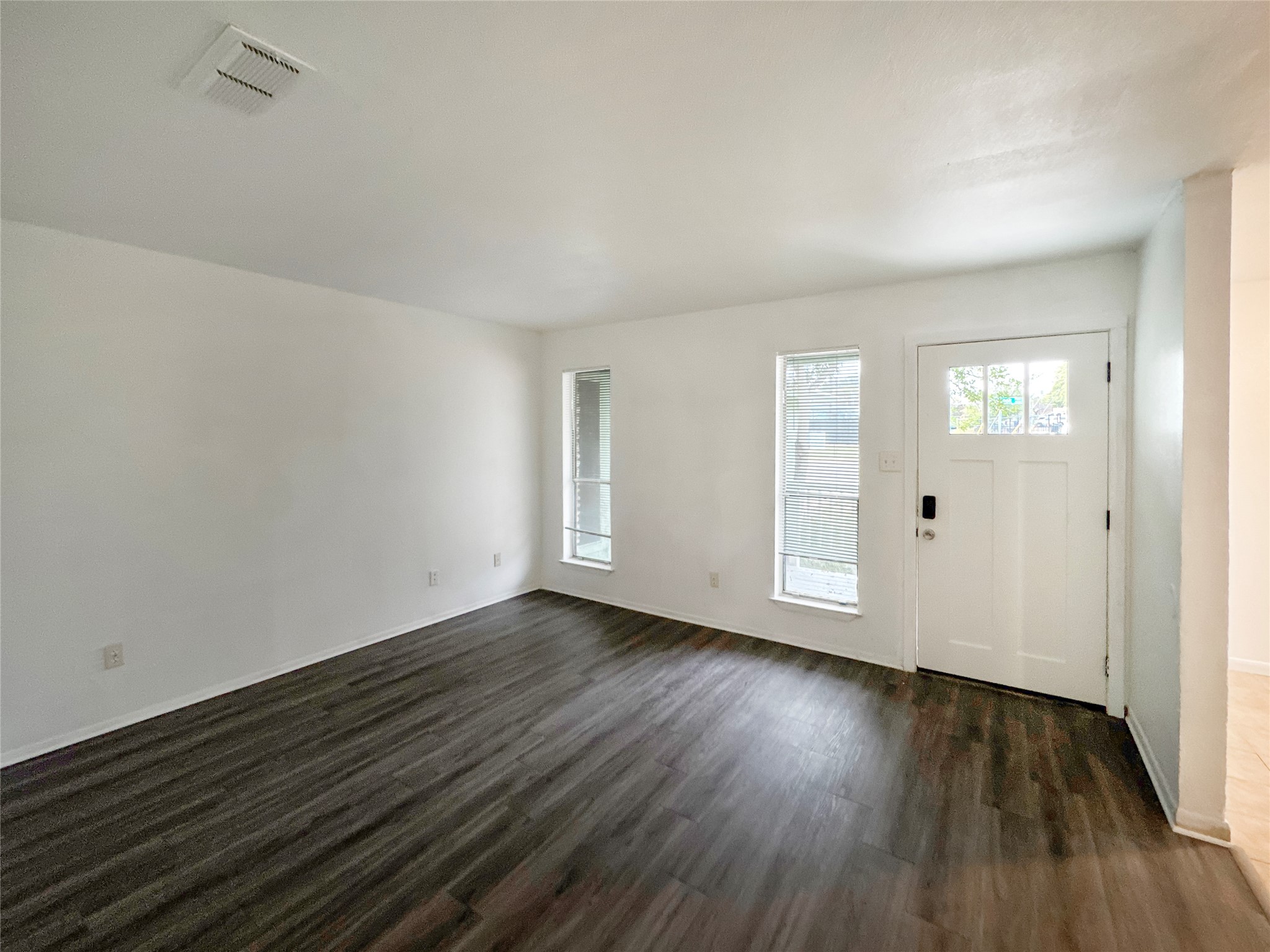 2017 Greenbrook Parkway, Unit B Austin, TX 78723 - Photo 3 of 14 Foyer entrance with healthy amount of natural light and dark wood-type flooring