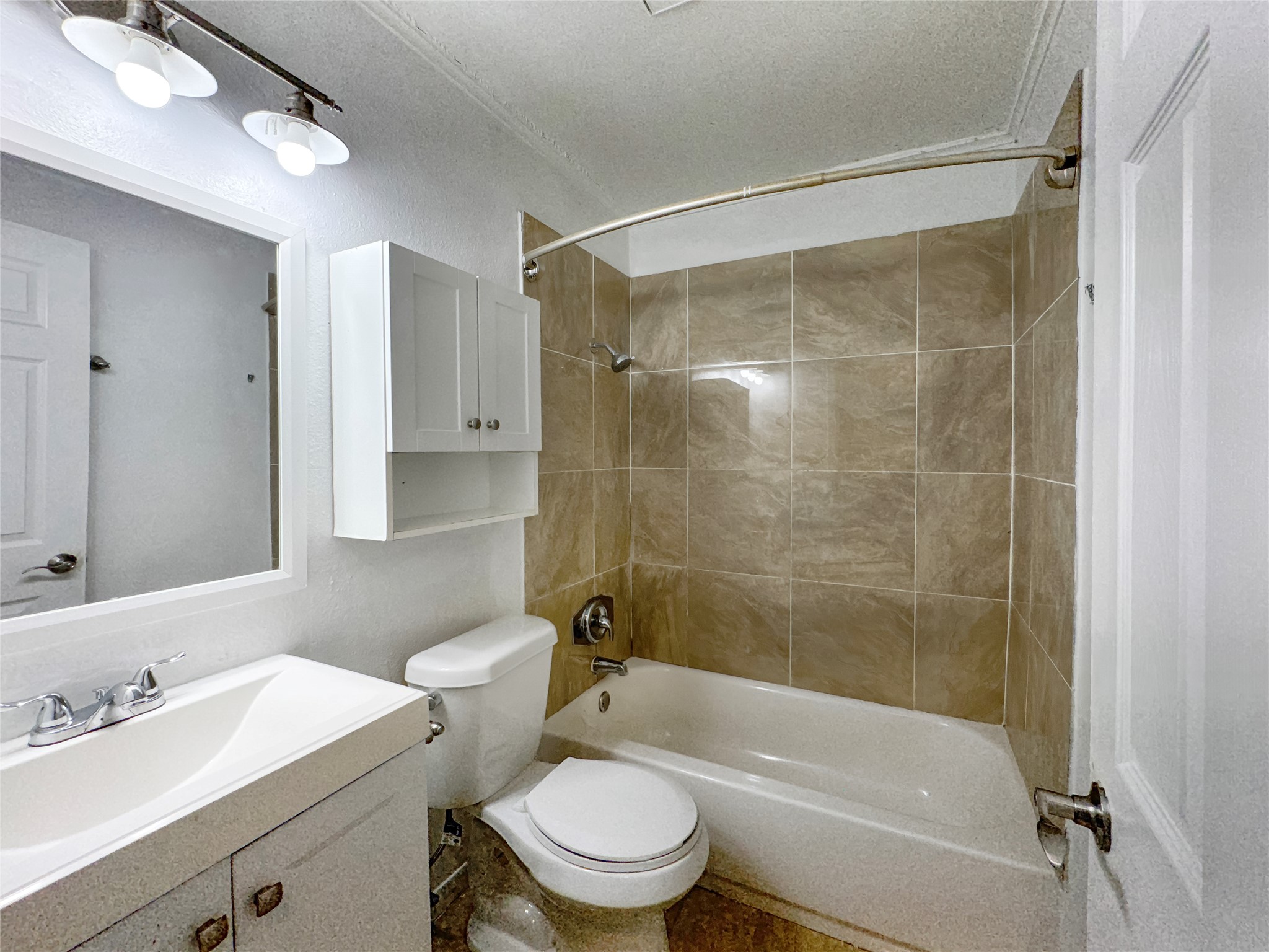 2017 Greenbrook Parkway, Unit B Austin, TX 78723 - Photo 8 of 14 Full bathroom with tub / shower combination, vanity, and a textured ceiling