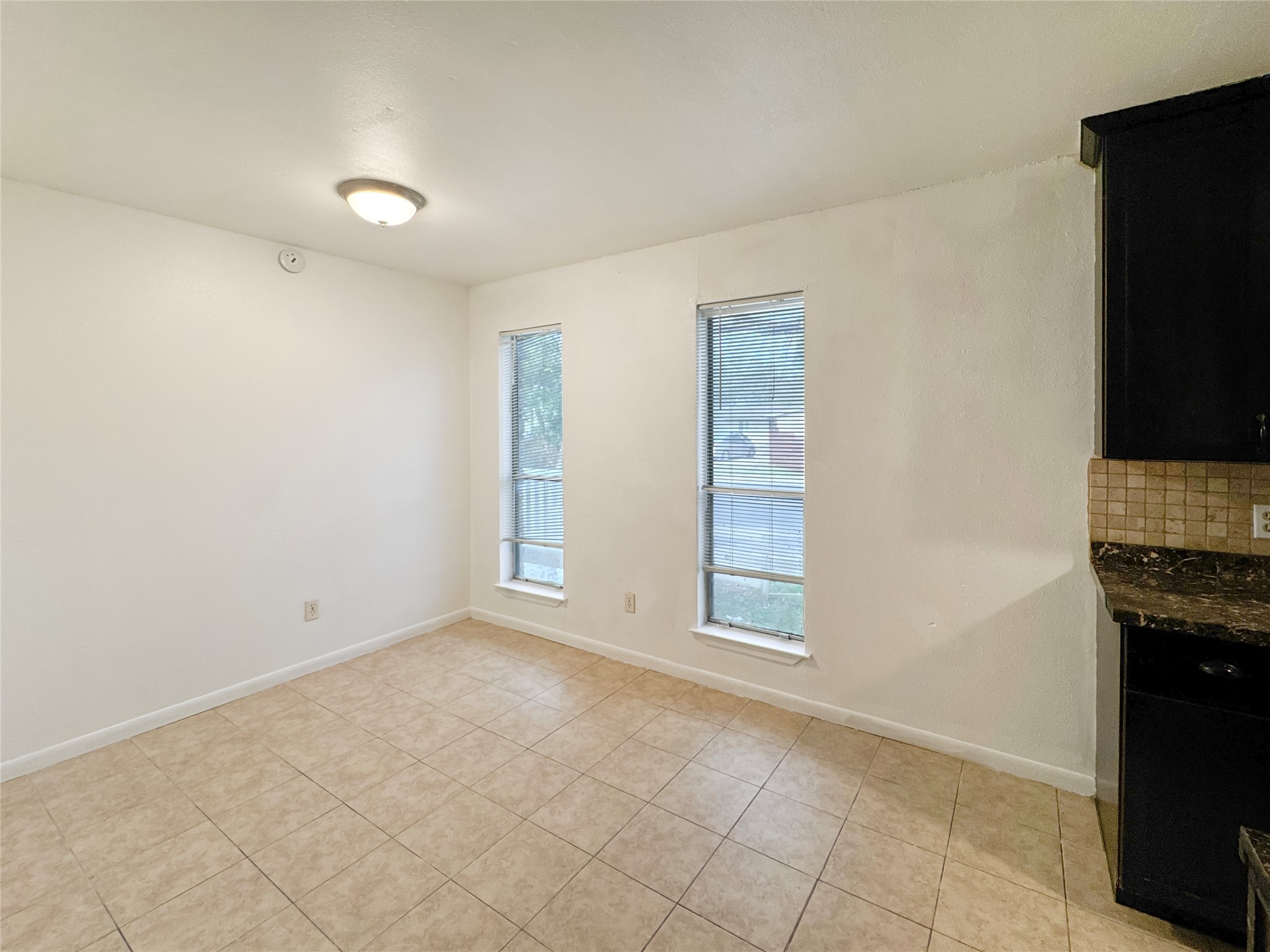 2017 Greenbrook Parkway, Unit B Austin, TX 78723 - Photo 9 of 14 Unfurnished dining area featuring baseboards and light tile patterned flooring