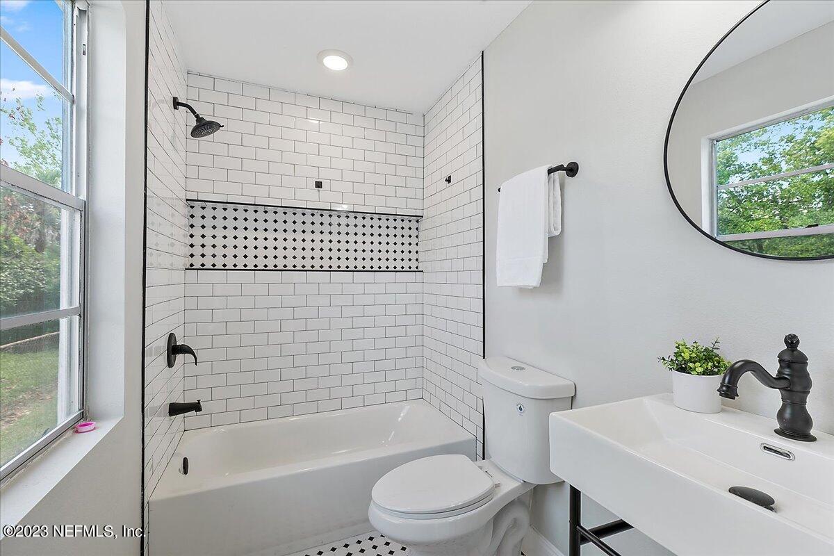 2435 Evernia Road Jacksonville, FL 32211 - Photo 11 of 15 a bathroom with a sink toilet and shower