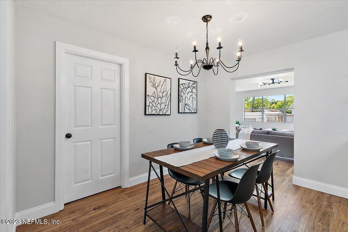 2435 Evernia Road Jacksonville, FL 32211 - Photo 6 of 15 a view of a dining room with furniture wooden floor and chandelier
