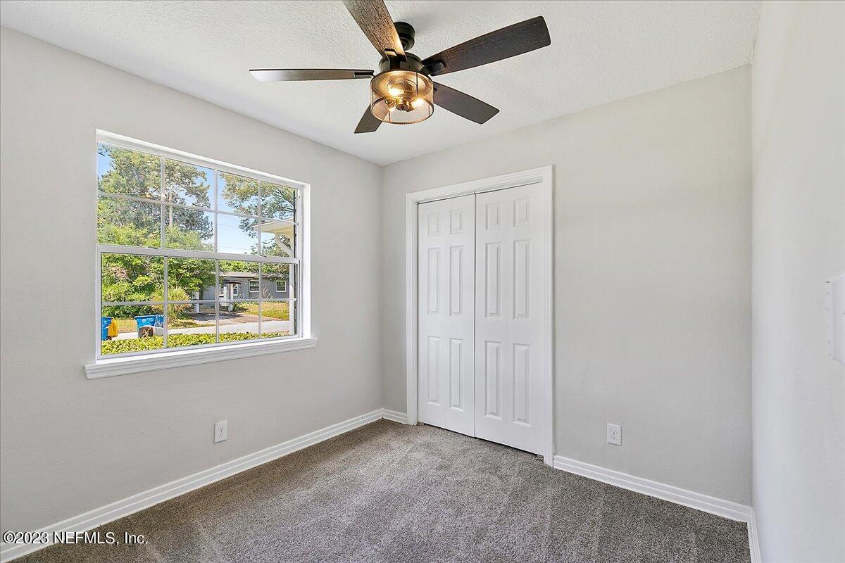 2435 Evernia Road Jacksonville, FL 32211 - Photo 10 of 15 an empty room with a window and a fan