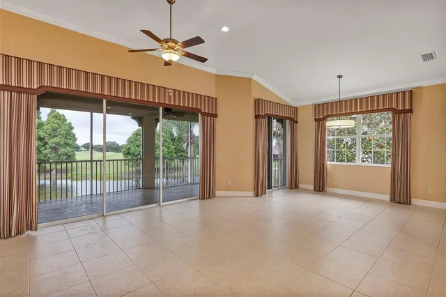 a view of a livingroom with a chandelier furniture and windows