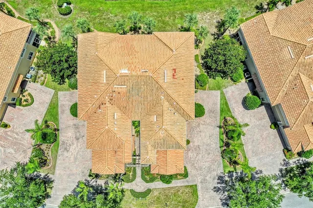 a view of a city with lawn chairs and large trees