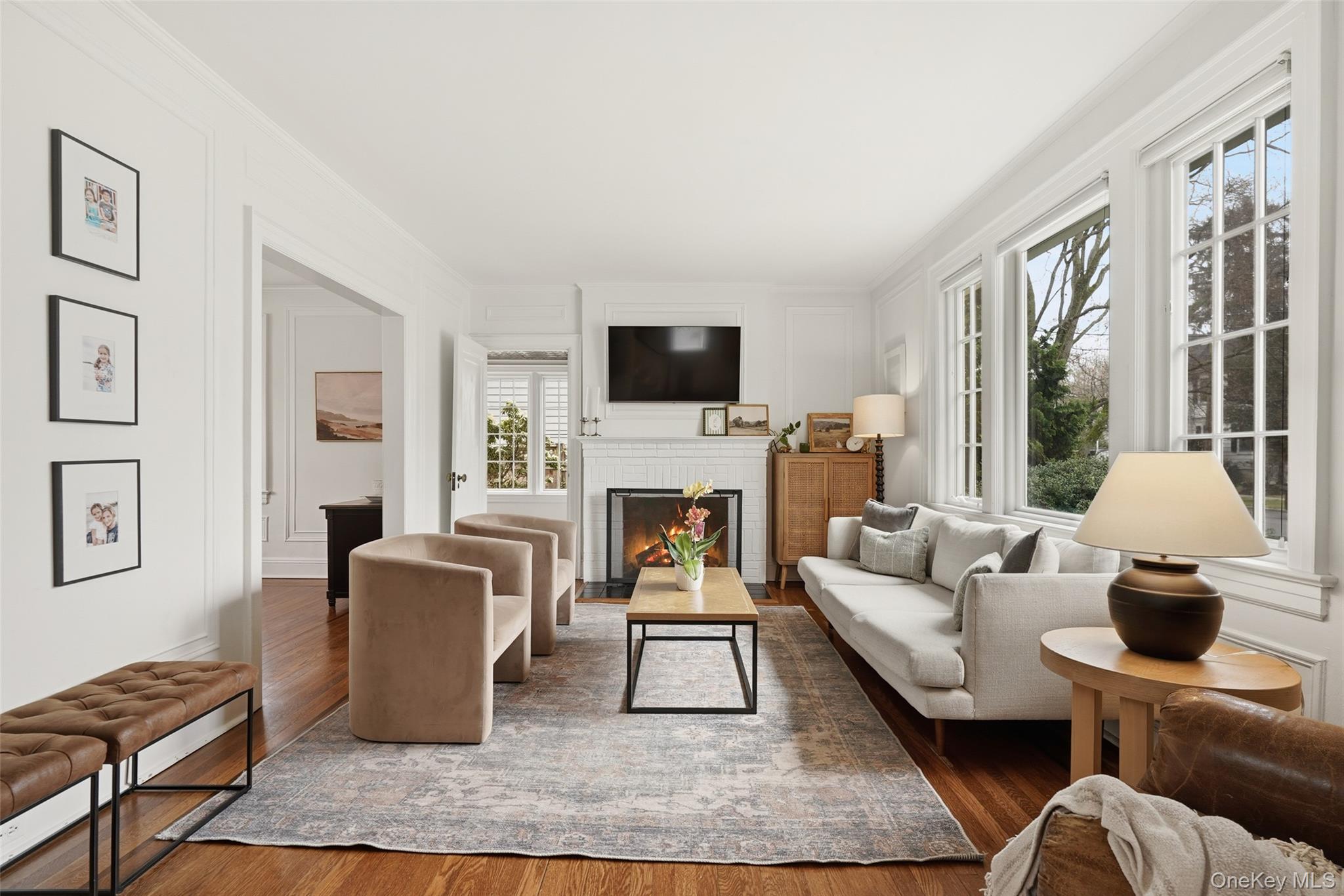 22 Brookdale Place Rye, NY 10580 - Photo 3 of 28 Living Room featuring a beautiful brick fireplace and wood floors