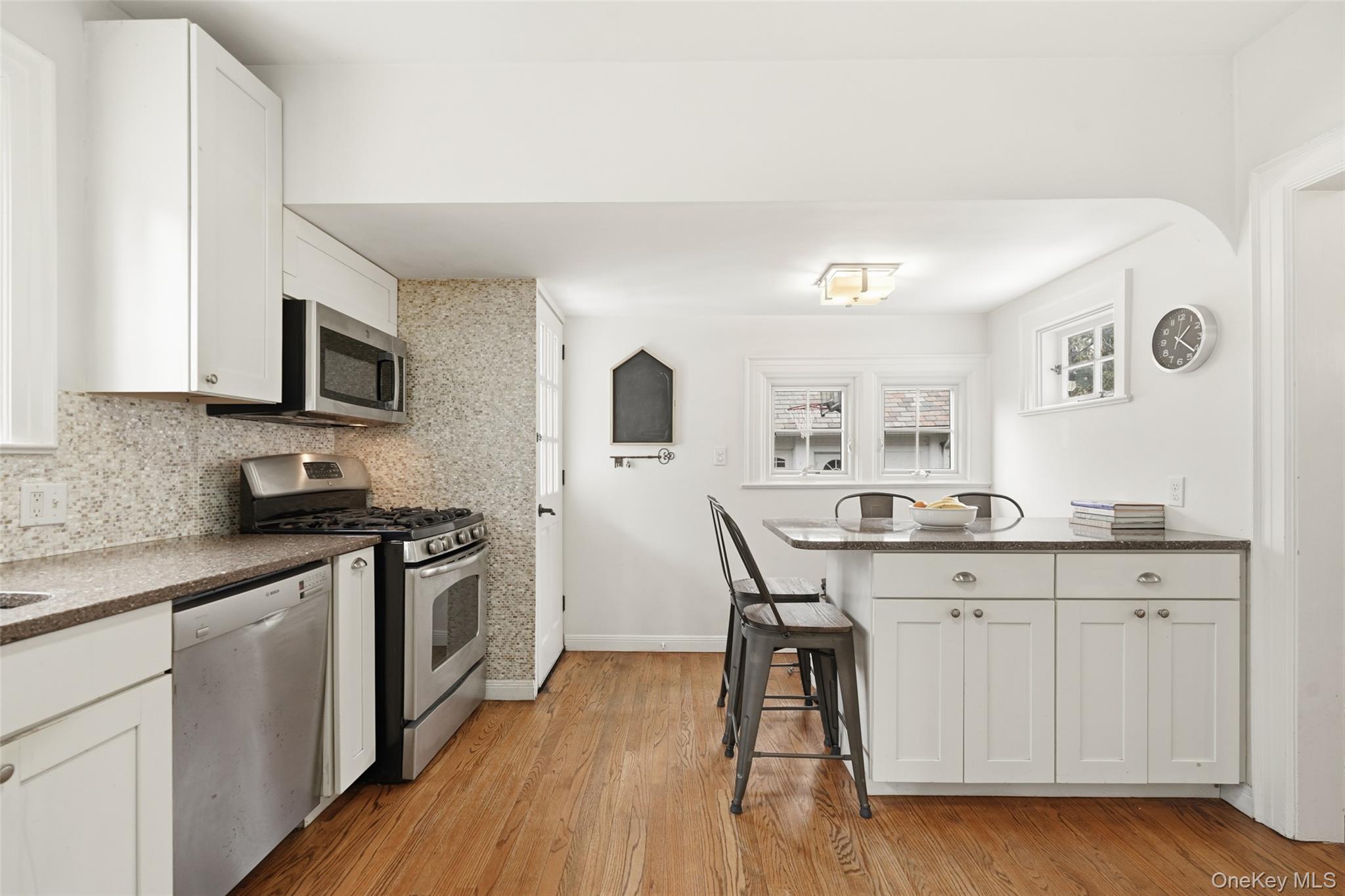 22 Brookdale Place Rye, NY 10580 - Photo 10 of 28 Kitchen featuring an eat-in island, stainless appliances