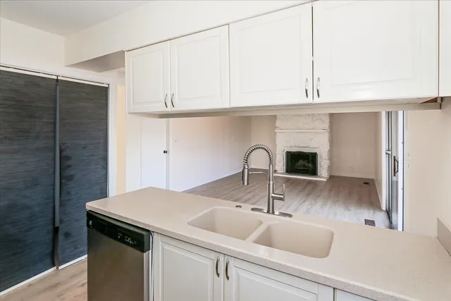 a kitchen with stainless steel appliances granite countertop a sink a refrigerator and cabinets