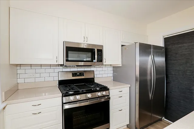 a kitchen with a stove and a microwave