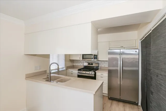 a kitchen with a refrigerator and a sink