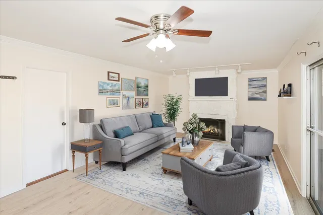 a living room with furniture a fireplace and a flat screen tv