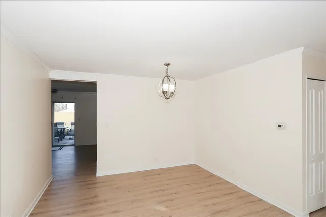 a view of a room with wooden floor and white walls