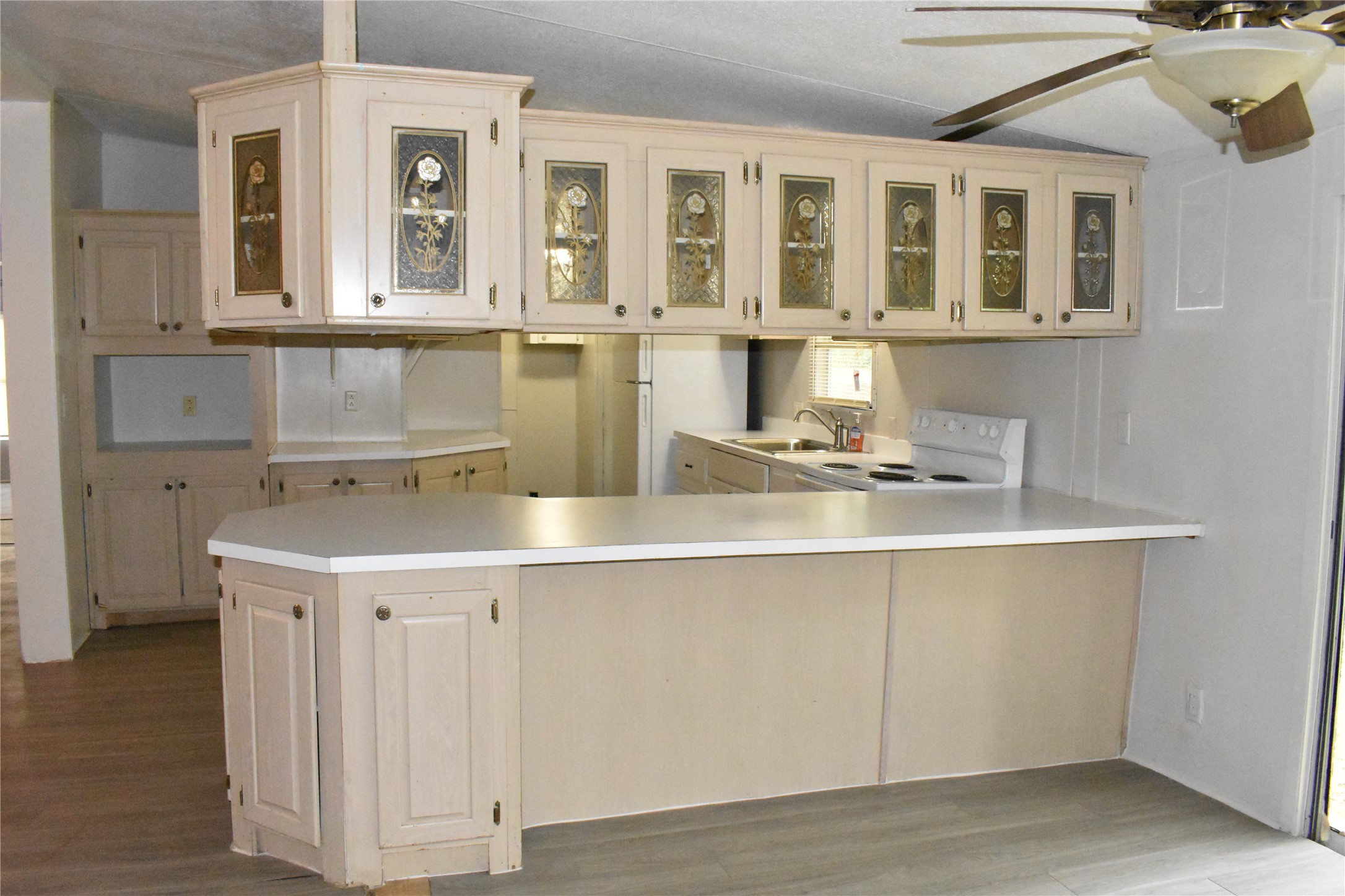 22530 Yancy Road Porter, TX 77365 - Photo 18 of 34 a kitchen with a sink cabinets and wooden floor