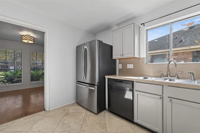 a kitchen with a sink stainless steel appliances and cabinets