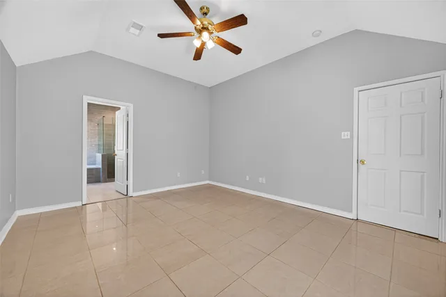 an empty room with closet and windows