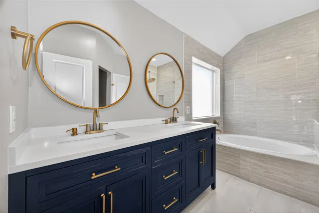 a bathroom with a double vanity sink and a mirror
