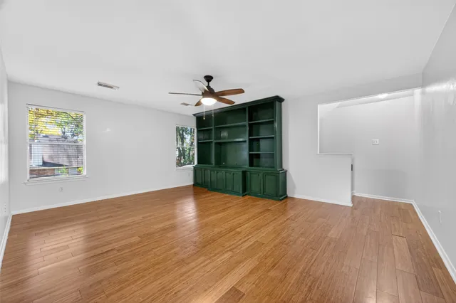 a view of an empty room with closet and a window