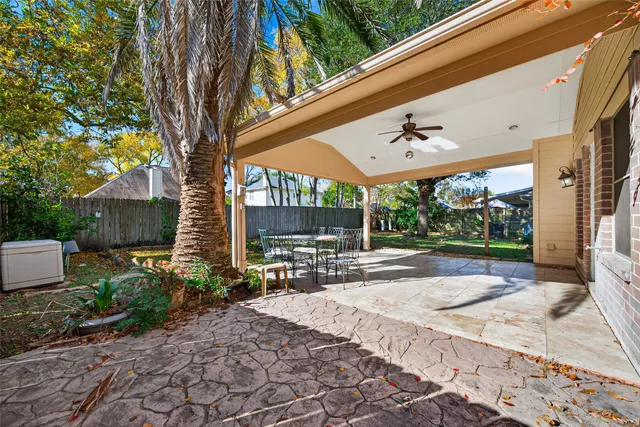 a view of a patio with a table chairs and a backyard