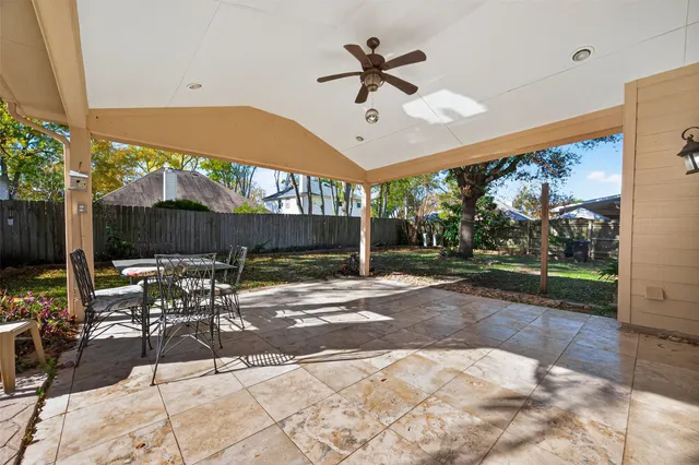 a view of a porch with a table and chairs