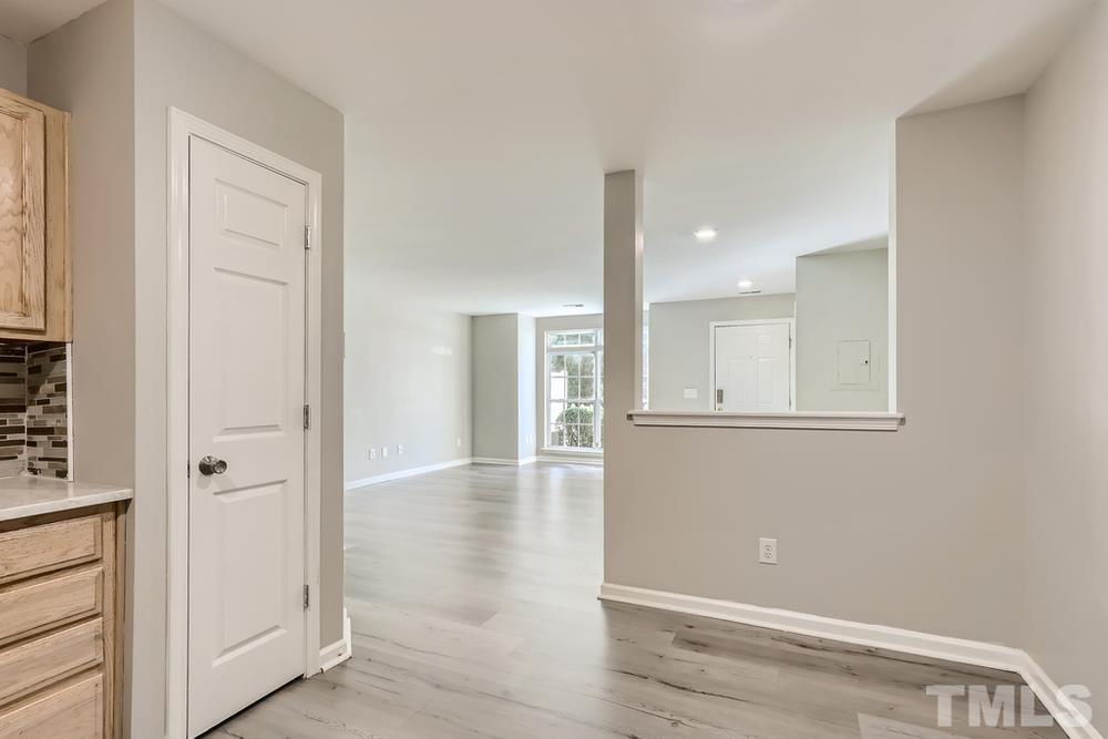8610 Neuse Landing Lane, Unit 109 Raleigh, NC 27616 - Photo 11 of 28 a view of an empty room with wooden floor and a window