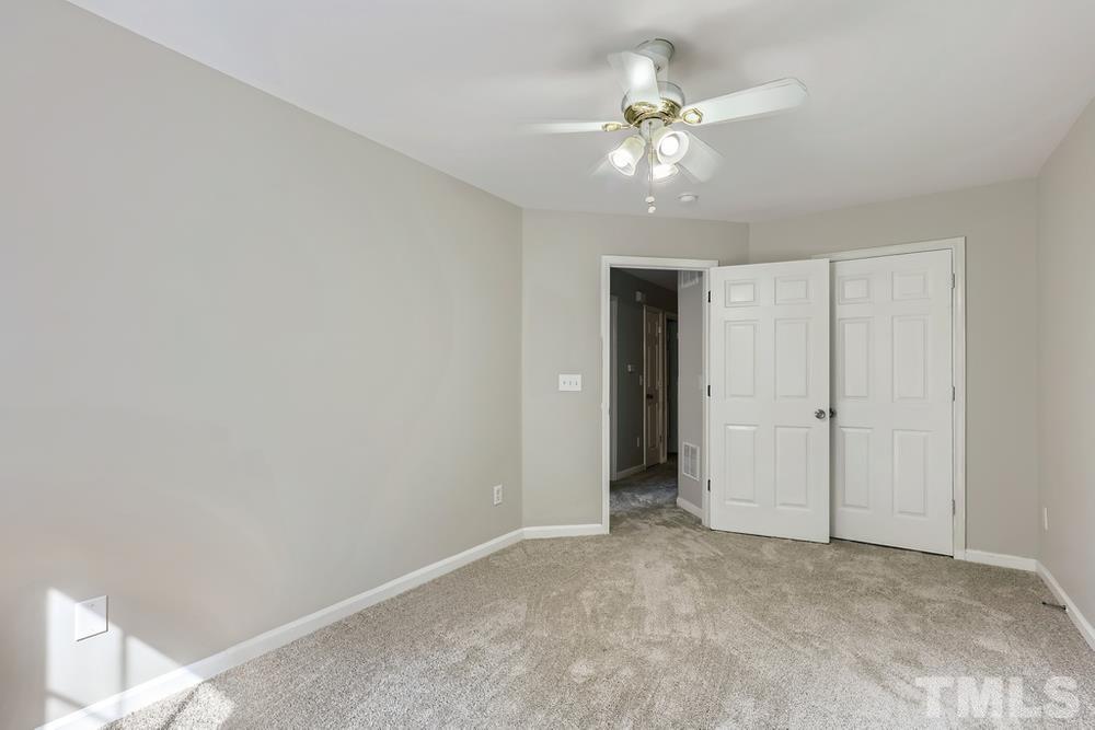 8610 Neuse Landing Lane, Unit 109 Raleigh, NC 27616 - Photo 14 of 28 a view of an empty room with chandelier fan