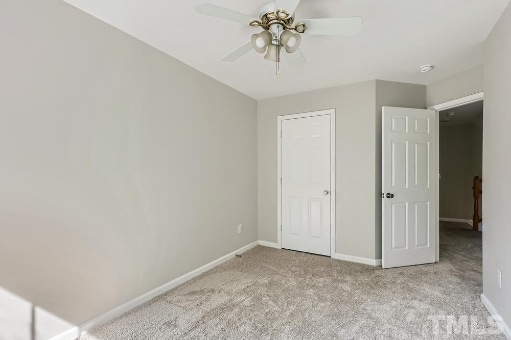 8610 Neuse Landing Lane, Unit 109 Raleigh, NC 27616 - Photo 17 of 28 a view of an empty room and chandelier fan