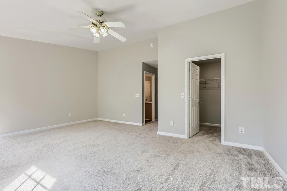 8610 Neuse Landing Lane, Unit 109 Raleigh, NC 27616 - Photo 22 of 28 a view of an empty room with a ceiling fan