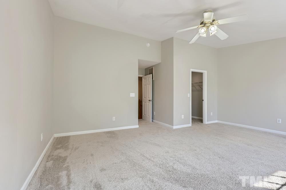 8610 Neuse Landing Lane, Unit 109 Raleigh, NC 27616 - Photo 23 of 28 a view of an empty room with a ceiling fan