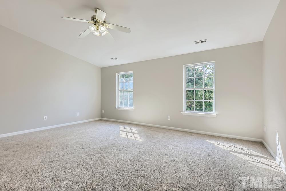 8610 Neuse Landing Lane, Unit 109 Raleigh, NC 27616 - Photo 24 of 28 an empty room with windows and ceiling fan