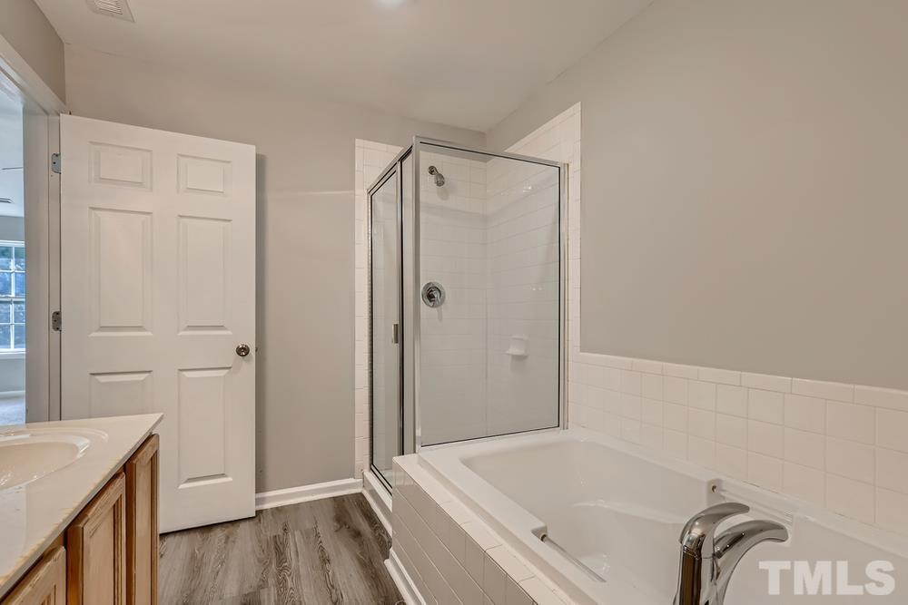 8610 Neuse Landing Lane, Unit 109 Raleigh, NC 27616 - Photo 26 of 28 a bathroom with a bathtub and a shower