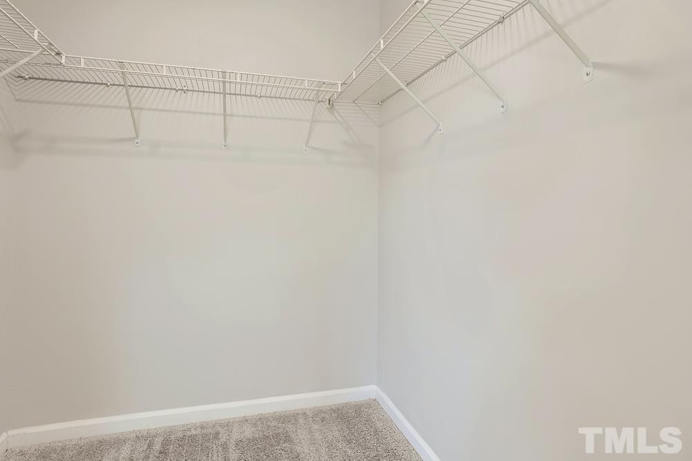 8610 Neuse Landing Lane, Unit 109 Raleigh, NC 27616 - Photo 27 of 28 a view of a room with racks on the wall