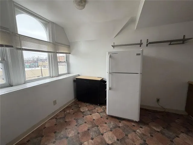 a kitchen with a refrigerator and a stove