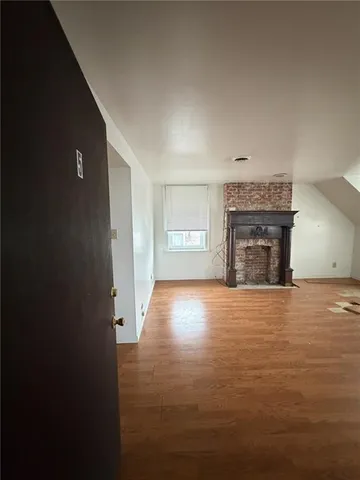 a view of empty room with a fireplace